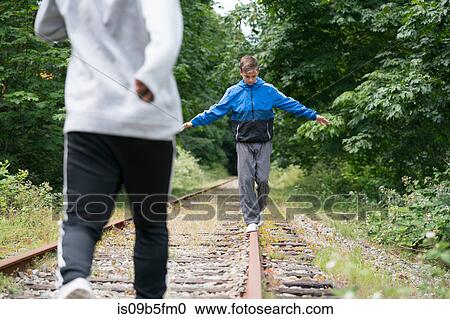 Teenage boys walking on railway track, Pacific Rim National Park, Vancouver Island, Canada View Large Photo Image Stock Image - Teenage boys walking on railway track, Pacific Rim National Park, Vancouver Island, Canada. Fotosearch