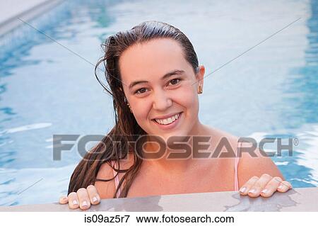Teenage girl in swimming pool looking at camera smiling View Large Photo Image Stock Photo - Teenage girl in swimming pool looking at camera smiling. Fotosearch