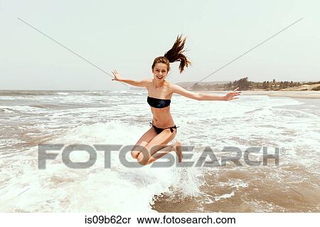 Teenage girl jumping in sea, Goa, India, Asia View Large Photo Image Stock Photography - Teenage girl jumping in sea, Goa, India, Asia. Fotosearch