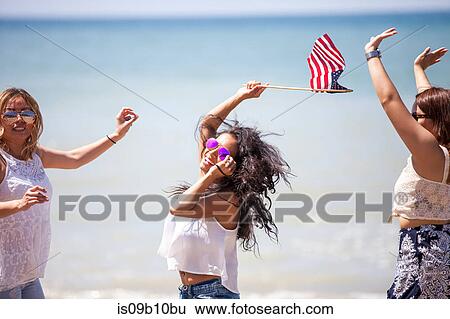 Three adult female friends waving American flag on beach, Malibu, California, USA View Large Photo Image Stock Photograph - Three adult female friends waving American flag on beach, Malibu, California, USA. Fotosearch