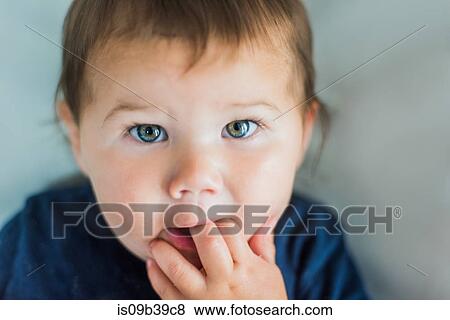 Stock Photo - Toddler with fingers in mouth. Fotosearch