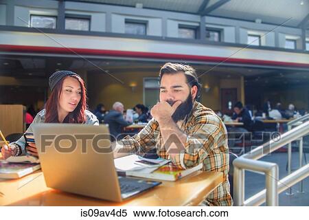 Two adult college students working on laptop at classroom desk View Large Photo Image Stock Photography - Two adult college students working on laptop at classroom desk. Fotosearch