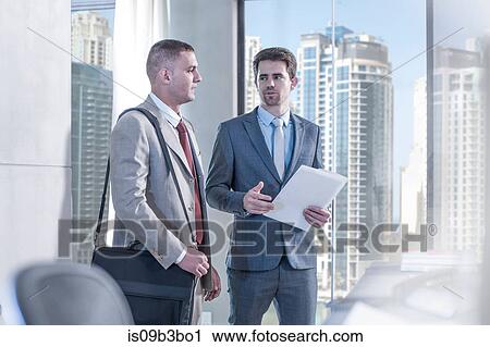 Two businessmen arriving in conference room with paperwork View Large Photo Image Stock Image - Two businessmen arriving in conference room with paperwork. Fotosearch