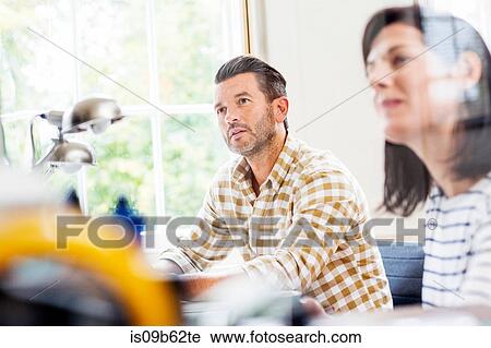 Two designers having meeting at desk in creative studio View Large Photo Image Stock Image - Two designers having meeting at desk in creative studio. Fotosearch