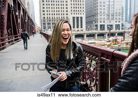 Two friends, standing on bridge, laughing View Large Photo Image Stock Image - Two friends, standing on bridge, laughing. Fotosearch