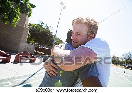 Two male friends congratulating each other after basketball game View Large Photo Image Stock Photography - Two male friends congratulating each other after basketball game. Fotosearch