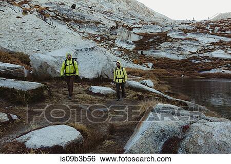 Stock Photograph - Two male hikers hiking by lake, Mineral King, Sequoia National Park, California, USA. Fotosearch