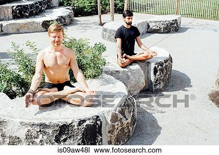 Two men meditating in lotus pose on park stone seats View Large Photo Image Stock Image - Two men meditating in lotus pose on park stone seats. Fotosearch