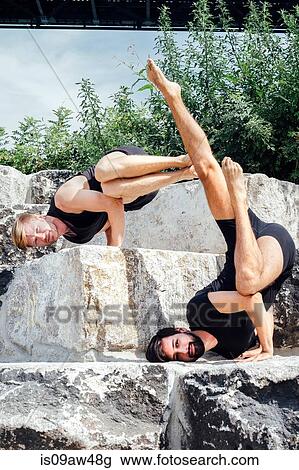 Two men practicing advanced yoga handstand on park step View Large Photo Image Stock Image - Two men practicing advanced yoga handstand on park step. Fotosearch