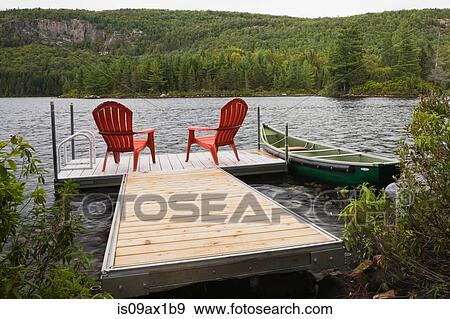 Two red adirondack chairs on floating dock on river View Large Photo Image Stock Photo - Two red adirondack chairs on floating dock on river. Fotosearch