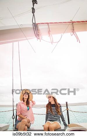 Two women on sitting on deck of sailing boat, on sea View Large Photo Image Stock Image - Two women on sitting on deck of sailing boat, on sea. Fotosearch