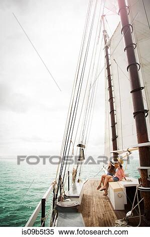Two women on sitting on deck of sailing boat, on sea View Large Photo Image Stock Photography - Two women on sitting on deck of sailing boat, on sea. Fotosearch
