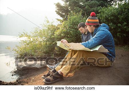 Two young male hikers reading map by lake, Mount Hood National Forest, Oregon, USA View Large Photo Image Stock Image - Two young male hikers reading map by lake, Mount Hood National Forest, Oregon, USA. Fotosearch
