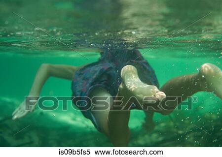 Underwater view of teenage boy swimming, Econfina Creek, Youngstown, Florida, USA View Large Photo Image Stock Photography - Underwater view of teenage boy swimming, Econfina Creek, Youngstown, Florida, USA. Fotosearch