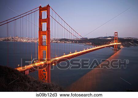 Stock Image - View of traffic light trails crossing Golden Gate Bridge at dusk, San Francisco, California, USA. Fotosearch