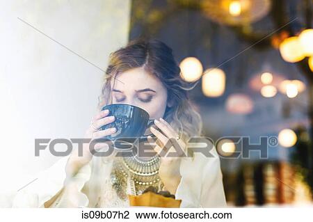 View through coffee shop window of woman drinking coffee View Large Photo Image Stock Image - View through coffee shop window of woman drinking coffee. Fotosearch