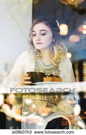 View through coffee shop window of woman with coffee View Large Photo Image Stock Image - View through coffee shop window of woman with coffee. Fotosearch