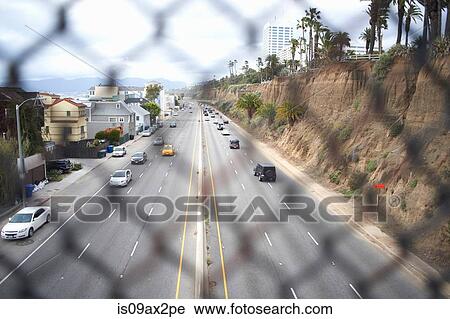 View through fence onto highway, Los Angeles, USA View Large Photo Image Stock Image - View through fence onto highway, Los Angeles, USA. Fotosearch