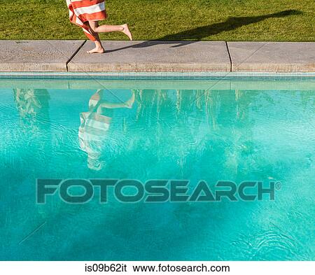Waist down view of boy wrapped in towel running on poolside View Large Photo Image Stock Photograph - Waist down view of boy wrapped in towel running on poolside. Fotosearch