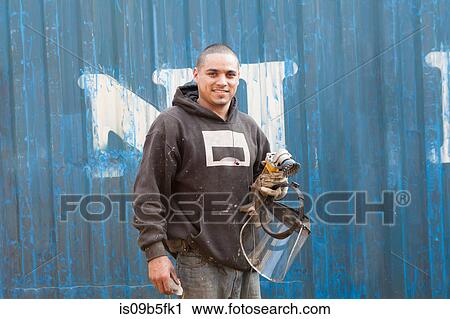 Welder holding welders mask smiling at camera View Large Photo Image Stock Image - Welder holding welders mask smiling at camera. Fotosearch