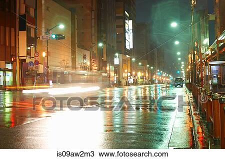 Wet city street and street lights at night, Tokyo, Japan View Large Photo Image Stock Image - Wet city street and street lights at night, Tokyo, Japan. Fotosearch