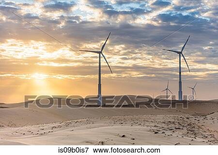 Wind turbines in desert landscape at sunset, Taiba, Ceara, Brazil View Large Photo Image Stock Photo - Wind turbines in desert landscape at sunset, Taiba, Ceara, Brazil. Fotosearch