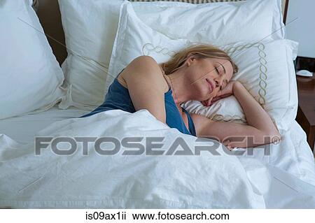 Stock Image - Woman asleep in bed. Fotosearch