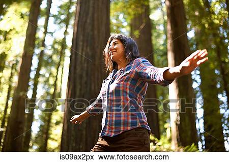 Woman balance walking in forest View Large Photo Image Stock Photo - Woman balance walking in forest. Fotosearch