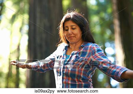 Stock Photo - Woman balance walking in forest. Fotosearch