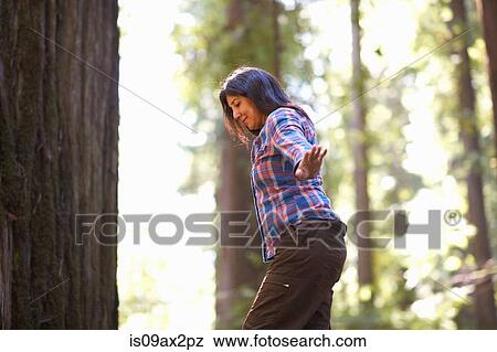 Woman balance walking in forest View Large Photo Image Stock Photo - Woman balance walking in forest. Fotosearch