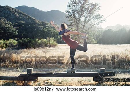 Woman by mountains doing stretching exercises, Malibu, California, USA View Large Photo Image Stock Photo - Woman by mountains doing stretching exercises, Malibu, California, USA. Fotosearch