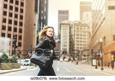 Woman crossing road in urban area, Boston, Massachusetts, USA View Large Photo Image Stock Image - Woman crossing road in urban area, Boston, Massachusetts, USA. Fotosearch