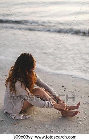 Woman daydreaming on beach View Large Photo Image Stock Photo - Woman daydreaming on beach. Fotosearch