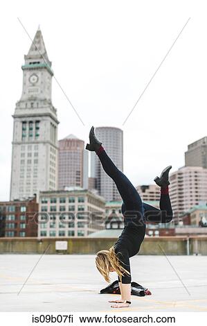 Woman doing handstand on rooftop, Boston, Massachusetts, USA View Large Photo Image Stock Image - Woman doing handstand on rooftop, Boston, Massachusetts, USA. Fotosearch