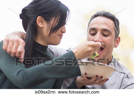Woman feeding man salad View Large Photo Image Picture - Woman feeding man salad. Fotosearch