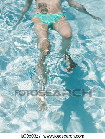 Woman floating in pool View Large Photo Image Stock Photo - Woman floating in pool. Fotosearch