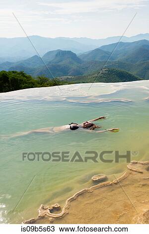 Woman floating in thermal spring, Hierve el Agua, Oaxaca, Mexico. View Large Photo Image Stock Image - Woman floating in thermal spring, Hierve el Agua, Oaxaca, Mexico.. Fotosearch