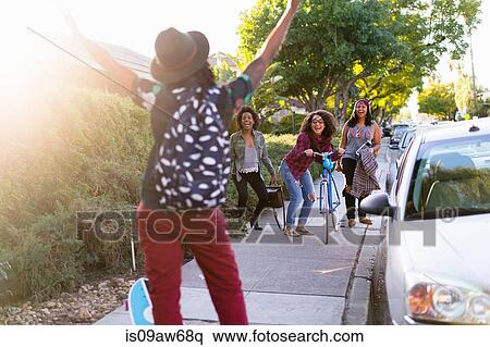 Woman gesturing to friends in street, rear view View Large Photo Image Stock Photography - Woman gesturing to friends in street, rear view. Fotosearch