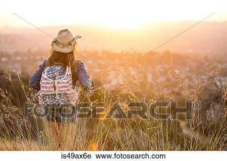 Woman hiking, wearing stars and stripes backpack, rear view View Large Photo Image Stock Image - Woman hiking, wearing stars and stripes backpack, rear view. Fotosearch