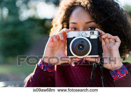 Woman holding retro camera View Large Photo Image Picture - Woman holding retro camera. Fotosearch
