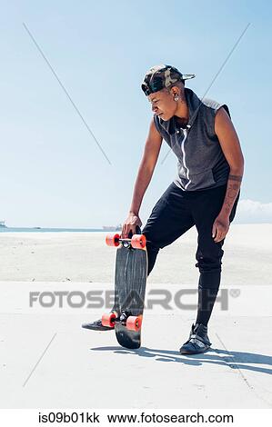 Woman holding skateboard View Large Photo Image Stock Image - Woman holding skateboard. Fotosearch