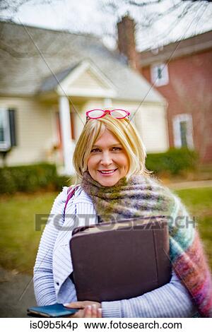 Stock Photography - Woman hugging large briefcase. Fotosearch