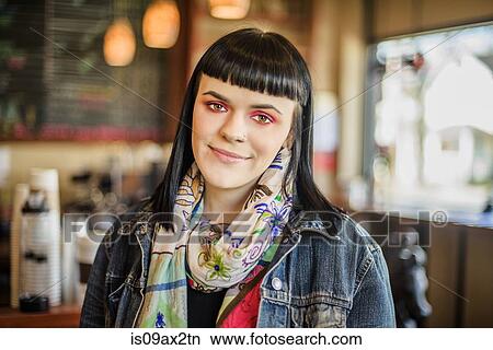 Woman in coffee shop looking at camera smiling View Large Photo Image Picture - Woman in coffee shop looking at camera smiling. Fotosearch