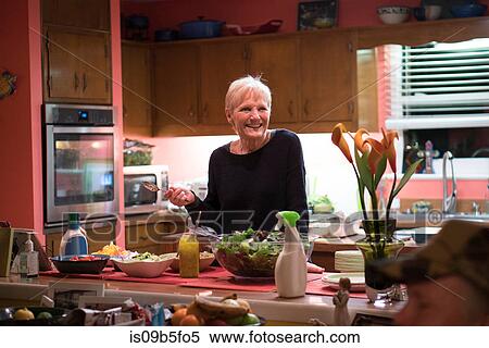 Woman in kitchen preparing meal View Large Photo Image Stock Photography - Woman in kitchen preparing meal. Fotosearch