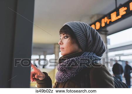 Woman in knit hat using touchscreen on railway ticket machine View Large Photo Image Stock Photo - Woman in knit hat using touchscreen on railway ticket machine. Fotosearch
