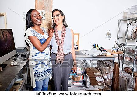 Woman in office side by side smiling View Large Photo Image Stock Photo - Woman in office side by side smiling. Fotosearch