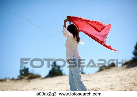 Woman in red shawl enjoying beach View Large Photo Image Stock Image - Woman in red shawl enjoying beach. Fotosearch