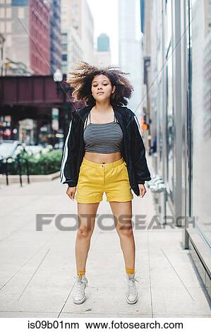 Picture - Woman jumping in street, Chicago, Illinois. Fotosearch