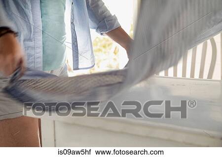 Woman laying cloth over table View Large Photo Image Stock Image - Woman laying cloth over table. Fotosearch