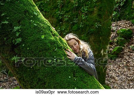 Woman leaning against moss covered tree, Spain View Large Photo Image Stock Photography - Woman leaning against moss covered tree, Spain. Fotosearch